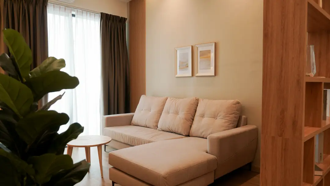 Living room with beige sofa, oak shelving and framed art