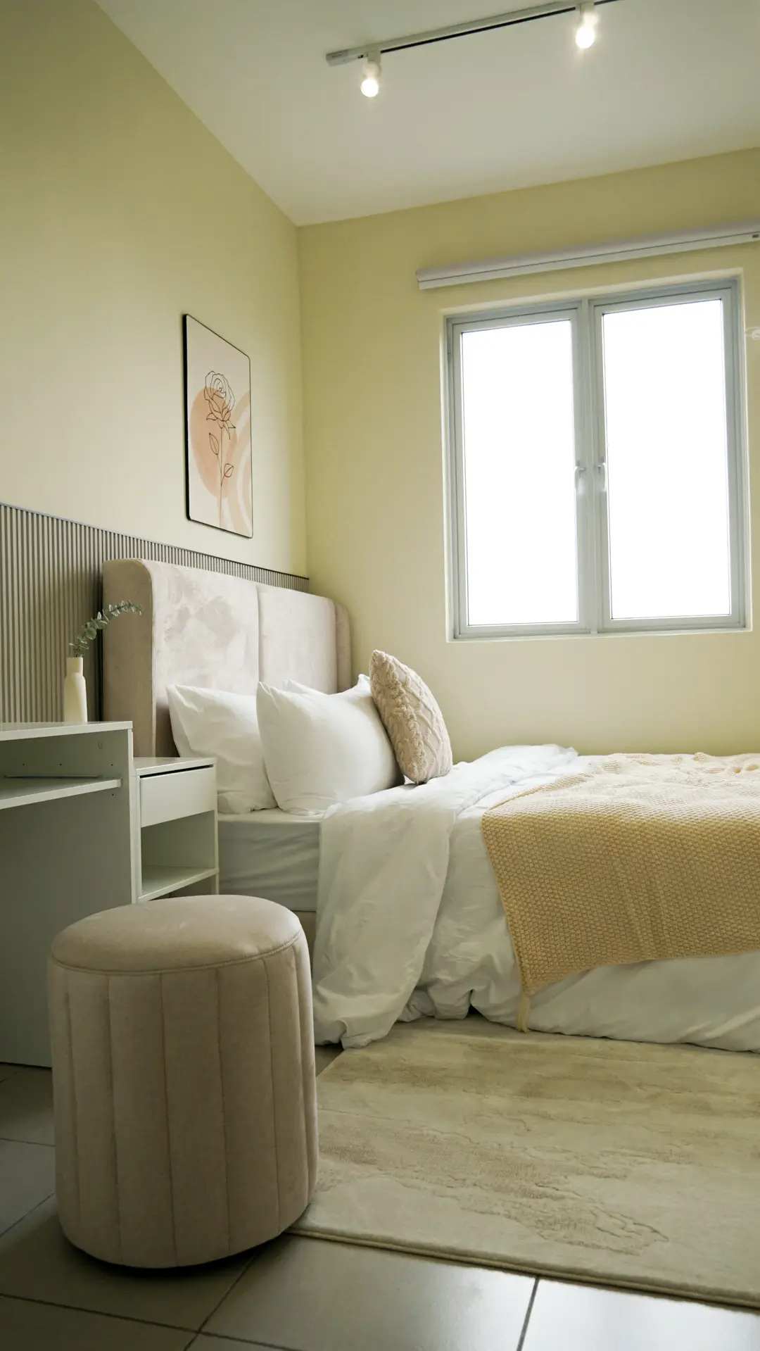 Bedroom in cream and soft yellow with upholstered headboard